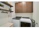 Laundry room with washer, dryer, and ample cabinetry for storage at 125 Soliera St, Nokomis, FL 34275