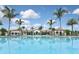 Community pool with lake view and clubhouse in background at 125 Soliera St, Nokomis, FL 34275
