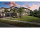 Two-story townhome exterior view at dusk with landscaping and street at 12530 Ghiberti Cir # 102, Venice, FL 34293