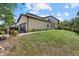 Side view of tan townhome with garage and landscaped yard at 12530 Ghiberti Cir # 102, Venice, FL 34293