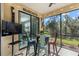 Bright screened porch with outdoor seating and string lights at 12530 Ghiberti Cir # 102, Venice, FL 34293