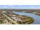 Community clubhouse with a pool overlooking the lake and surrounding homes at 12837 Oriago St, Venice, FL 34293