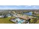 Panoramic aerial view of a community showcasing pools, tennis courts, and residential properties, illustrating a vibrant neighborhood at 12837 Oriago St, Venice, FL 34293