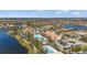 Panoramic aerial shot of a community showcasing pools, clubhouse, and well-maintained residences near a tranquil lake at 12837 Oriago St, Venice, FL 34293