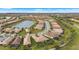 Aerial view of community with lake and homes at 12837 Oriago St, Venice, FL 34293