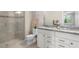 Main bathroom with a shower and double vanity at 12837 Oriago St, Venice, FL 34293