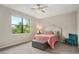 Bedroom with bed, chair, and large window at 12837 Oriago St, Venice, FL 34293