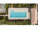 Aerial view of the community lap pool with lounge chairs and neatly landscaped surroundings at 12837 Oriago St, Venice, FL 34293