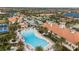 Stunning aerial view of community pool and clubhouse, featuring a resort-style atmosphere with palm trees at 12837 Oriago St, Venice, FL 34293