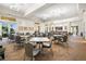 Large dining area featuring neutral colors and stylish lighting for comfortable gatherings and entertaining at 12837 Oriago St, Venice, FL 34293