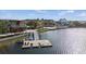 Picturesque lakeside view featuring a dock, calm water, and attractive buildings in the background at 12837 Oriago St, Venice, FL 34293
