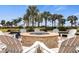 Outdoor fire pit area surrounded by white Adirondack chairs, perfect for relaxing evenings under the stars at 12837 Oriago St, Venice, FL 34293