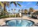 Inviting hot tub with clear blue water, surrounded by lush landscaping and a luxurious community pool area at 12837 Oriago St, Venice, FL 34293