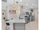 Gray kitchen cabinets, granite counters, and stainless steel appliances at 12837 Oriago St, Venice, FL 34293