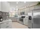 Spacious kitchen featuring stainless steel appliances and gray cabinets at 12837 Oriago St, Venice, FL 34293