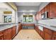 Spacious kitchen area with stainless steel appliances and a scenic view of the ocean through a bright window at 12837 Oriago St, Venice, FL 34293