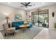 Comfortable living room with teal sectional sofa and access to screened lanai at 12837 Oriago St, Venice, FL 34293