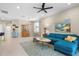 Living room with teal sectional sofa and view of screened lanai and hot tub at 12837 Oriago St, Venice, FL 34293