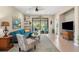 Spacious living area with teal sectional sofa, sliding doors to lanai, and hot tub at 12837 Oriago St, Venice, FL 34293