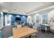 Bright meeting room with tables, chairs, and large windows overlooking the outdoors at 12837 Oriago St, Venice, FL 34293