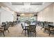 Community meeting room featuring tables, chairs and tv for gatherings and events at 12837 Oriago St, Venice, FL 34293