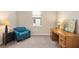 Home office with wood desk and comfy teal armchair at 12837 Oriago St, Venice, FL 34293