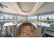 Spacious outdoor kitchen featuring marble countertops, plenty of seating, and clear views, perfect for entertaining at 12837 Oriago St, Venice, FL 34293