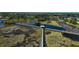 Scenic aerial view of a wooden boardwalk trail winding through a marsh landscape with a gazebo at 12837 Oriago St, Venice, FL 34293