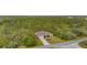 House nestled in a wooded area with a long driveway at 13156 Dodds Ct, Port Charlotte, FL 33953