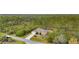 House nestled in a wooded area with a long driveway at 13156 Dodds Ct, Port Charlotte, FL 33953