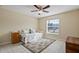 Bedroom with day bed, ceiling fan, and large window at 13156 Dodds Ct, Port Charlotte, FL 33953