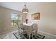 Bright dining room with window and white table setting at 13156 Dodds Ct, Port Charlotte, FL 33953