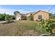 Tan house with a well-maintained lawn and landscaping at 13156 Dodds Ct, Port Charlotte, FL 33953