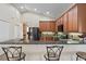 Kitchen features wood cabinets, granite counters, and breakfast bar seating at 13156 Dodds Ct, Port Charlotte, FL 33953