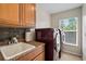 Laundry room with washer, dryer, sink, and cabinets at 13156 Dodds Ct, Port Charlotte, FL 33953