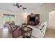 Spacious living room with leather sofas and entertainment center at 13156 Dodds Ct, Port Charlotte, FL 33953