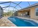 Inviting screened-in pool and patio with seating area at 13156 Dodds Ct, Port Charlotte, FL 33953