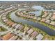 Aerial view of community with lake and homes at 13280 Esposito St, Venice, FL 34293