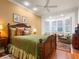 Bedroom with a green comforter and built-in seating area at 1720 Grande Park Dr, Englewood, FL 34223
