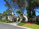 Community clubhouse with lush landscaping at 1720 Grande Park Dr, Englewood, FL 34223