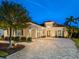 Elegant home with a paver driveway and beautifully landscaped yard at 1720 Grande Park Dr, Englewood, FL 34223