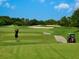 Golfer teeing off on a beautiful golf course at 1720 Grande Park Dr, Englewood, FL 34223