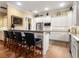 Modern kitchen with white cabinets, granite counters, and stainless steel appliances at 1720 Grande Park Dr, Englewood, FL 34223