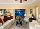 Elegant living room featuring comfortable seating, large windows, and a view to the patio at 1720 Grande Park Dr, Englewood, FL 34223