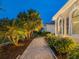 Brick walkway leading to the house entrance with palm trees at 1720 Grande Park Dr, Englewood, FL 34223