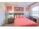 Bedroom with coral bedding and beach decor at 20121 Lagente Cir, Venice, FL 34293