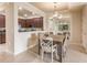 Dining room features a wood table and access to kitchen at 20121 Lagente Cir, Venice, FL 34293