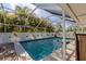 Inviting screened pool with tropical landscaping at 20263 Hamilton Ave, Port Charlotte, FL 33952