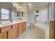 Bathroom boasts a large soaking tub and double vanity at 20272 Tesoro Dr, Venice, FL 34293