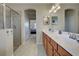 Double vanity bathroom with a walk-in shower and view of bedroom at 20272 Tesoro Dr, Venice, FL 34293